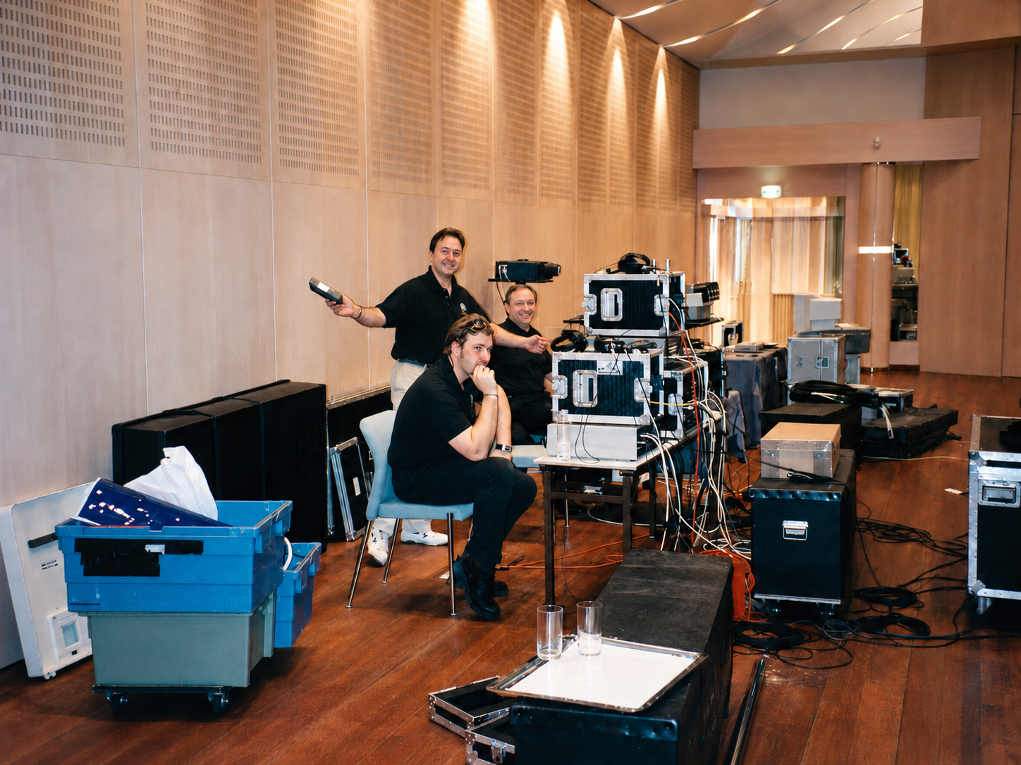 Audiovisual technicians and equipment behind the stage at a Novartis meeting in Monaco
