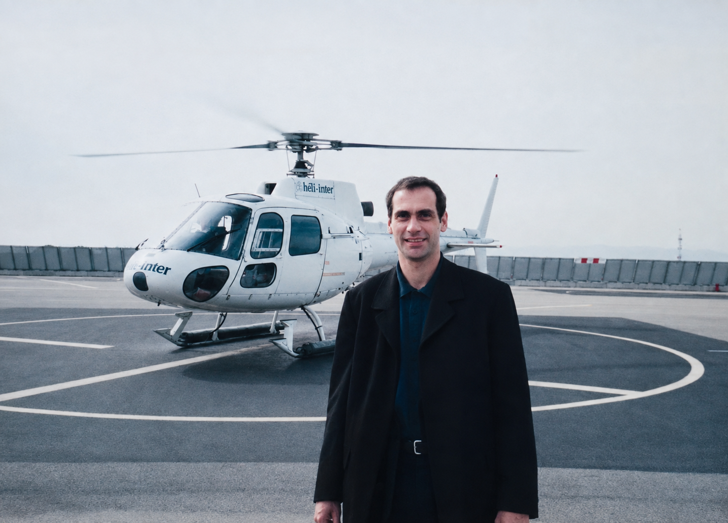 Nigel T. Heffer beside a helicopter before flying from Nice to Monaco for a conference