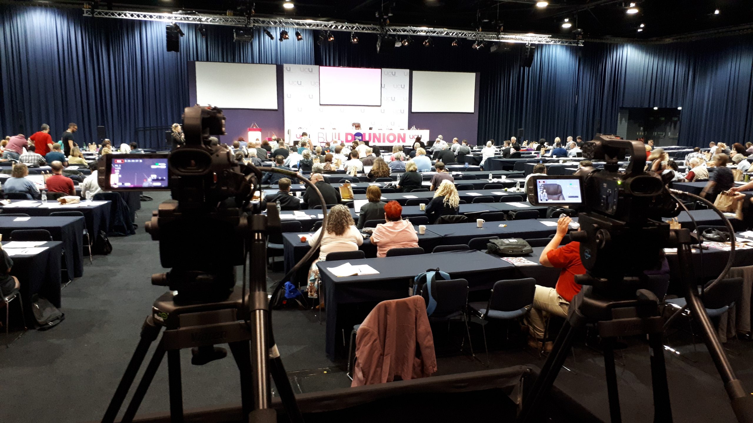 Crew at the back of the room during a union event in Manchester
