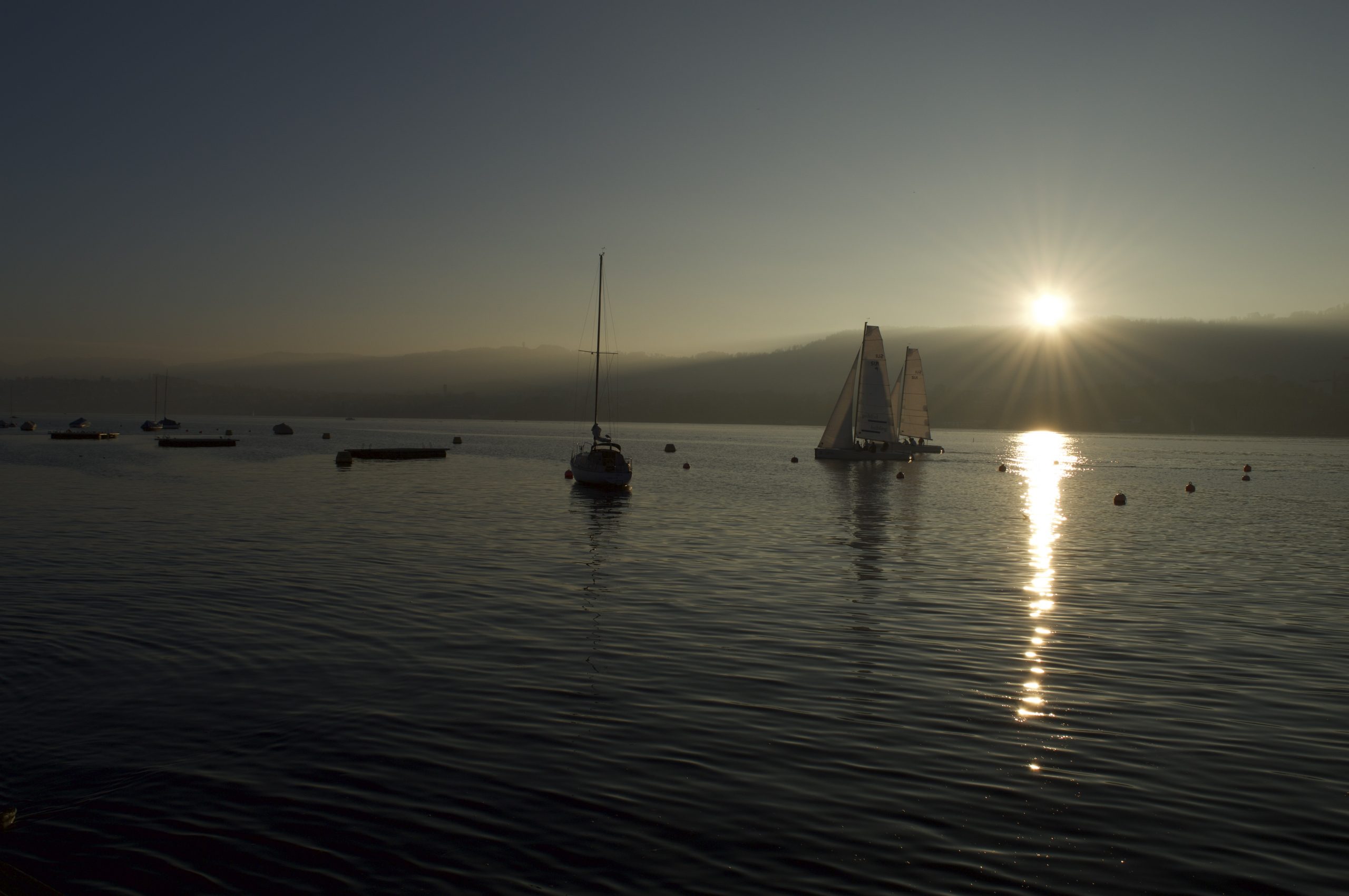 Zurich conference venues: Boat on Lake Zurich at sunset during a cold November visit